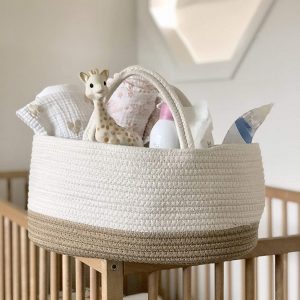 cotton diaper bag filled with baby accessories in the nursery